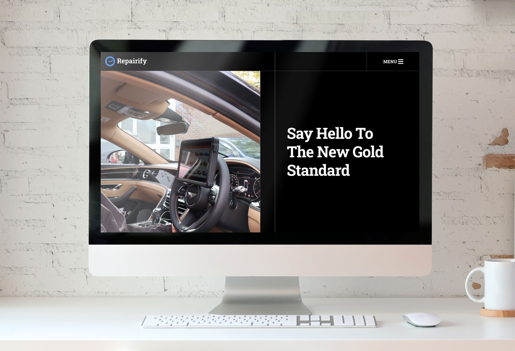 Desktop computer on a desk in a bright room with Repairify UK site on the screen