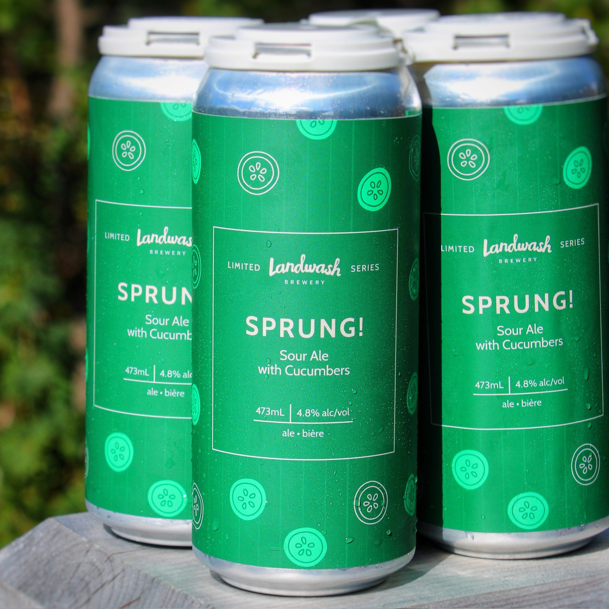 Four pack of 473mL beer cans with green labels and cucumber slice illustrations
